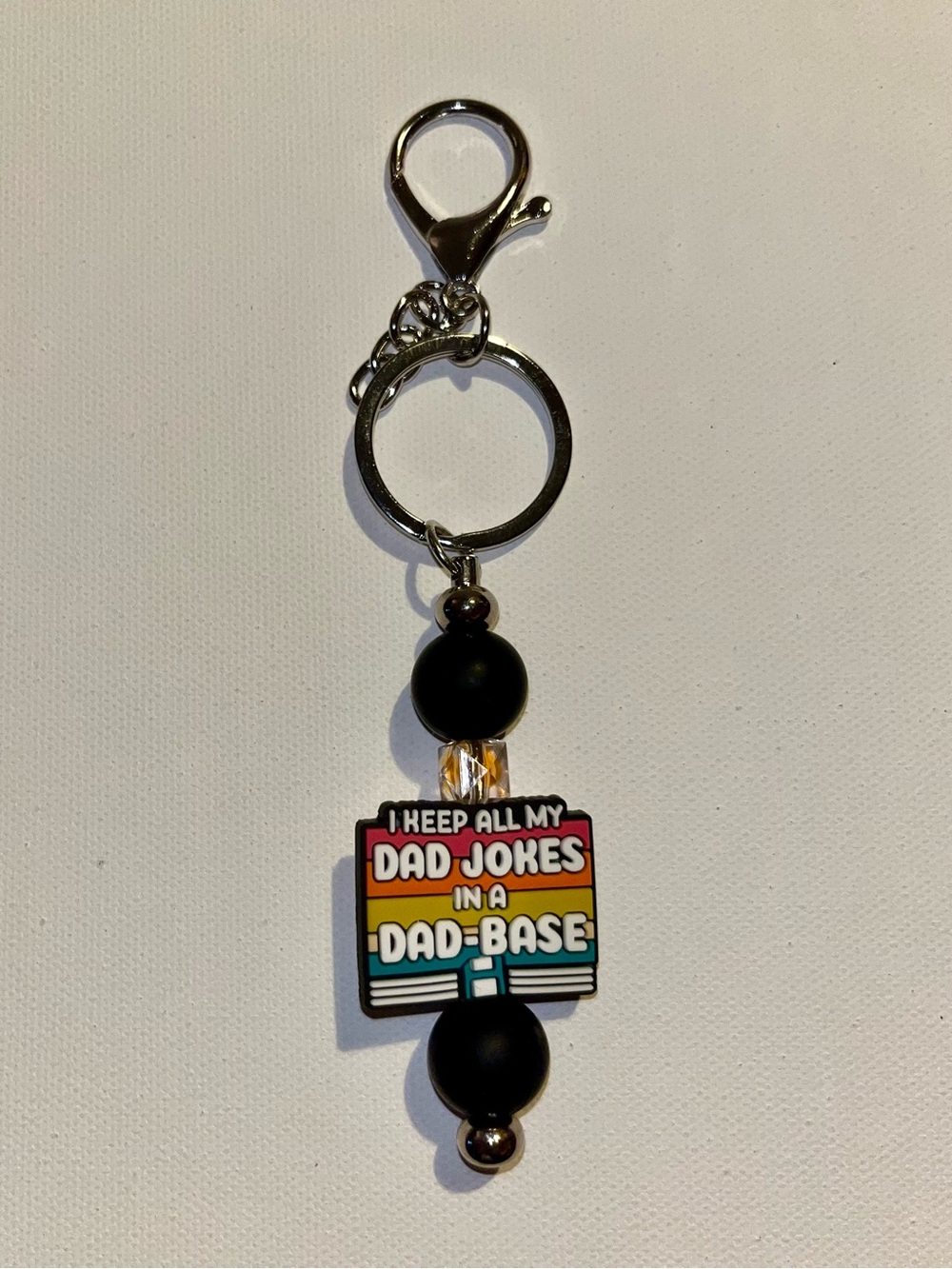 ‘I Keep All My Jokes in a Dad-Base’ Black with Retro Stripes Keychain
